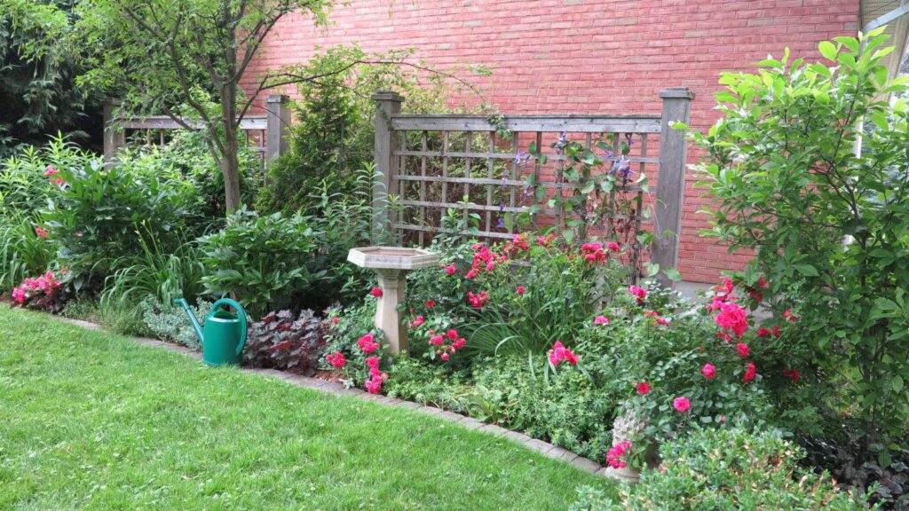 Wide planting beds are easier to design because they provide space for focal points, such as birdbaths or columnar trees. (<em>Garden Making</em> photo)